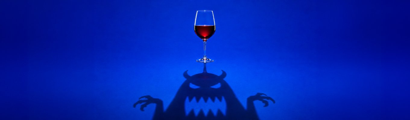 Taça de vinho com sombra em forma de monstro, imagem sobre mitos sobre vinho desmentidos pela ciência.